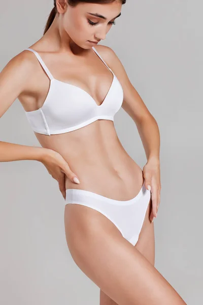 Mulher magra com corpo perfeito em roupa interior branca — Fotografia de Stock