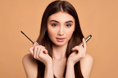 Kadın maskarası bej arka planda izole edilmiş.