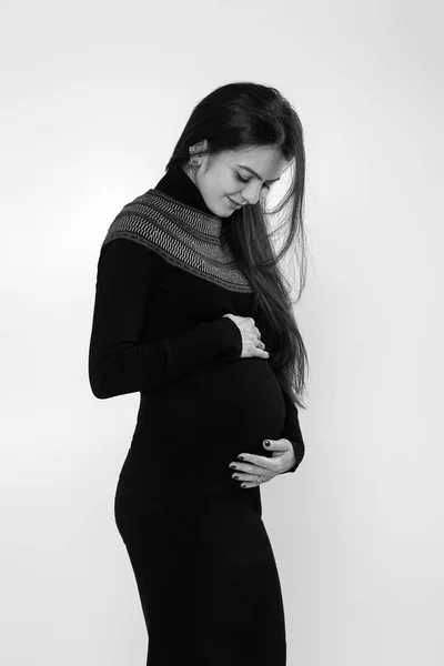 Hermosa mujer embarazada en vestido sosteniendo su vientre — Foto de Stock