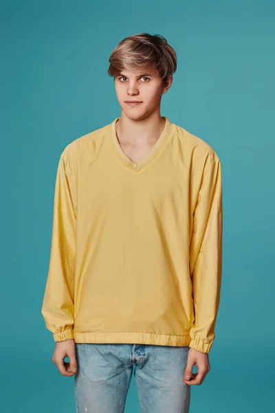 Giovane bel ragazzo in giallo maglione in posa — Foto Stock