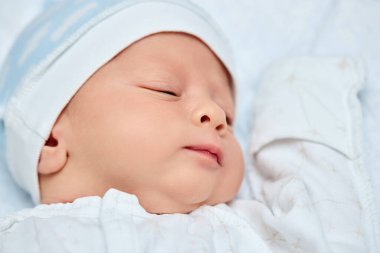 adorable new born baby sleeping in bed
