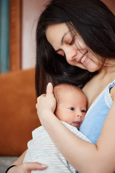 Young mother holding her cute newborn baby — Stock Photo, Image