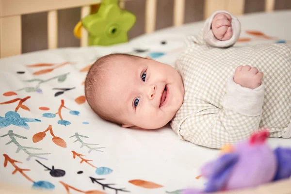 快乐可爱的新生儿在家里的婴儿床里 — 图库照片