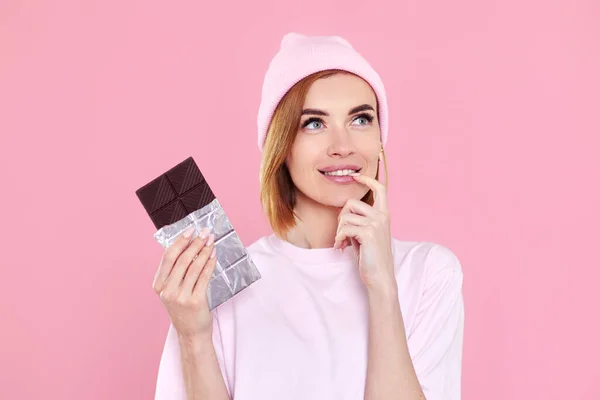 Stylish Young Blonde Woman Shirt Hat Holding Chocolate Bar Pink — 스톡 사진