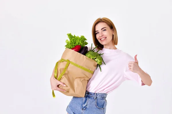 Smiling Caucasian Sporty Woman Holds Paper Bag Vegetables Measuring Tape — Foto de Stock