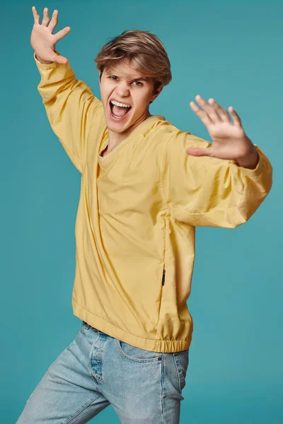 Excited Young Man Casual Yellow Clothes Dancing Isolated Pastel Blue — Foto Stock