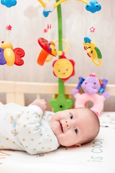 Smiling Cute Newborn Baby Playing Mobile Crib Home — Stock Photo, Image