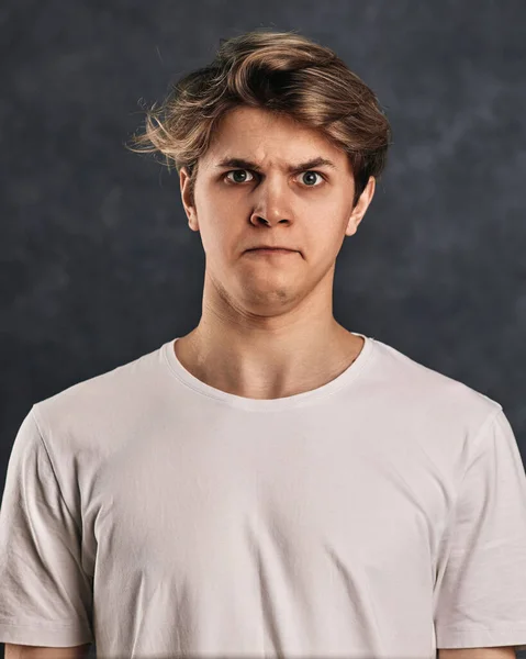Young Guy Grimacing Dark Gray Background — 스톡 사진