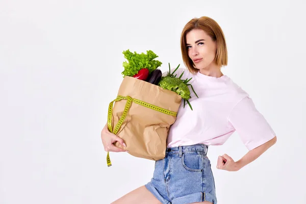 Young Sporty Woman Holds Paper Bag Vegetables Measuring Tape White — Foto de Stock