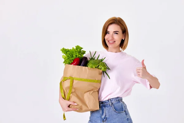 Smiling Caucasian Sporty Woman Holds Paper Bag Vegetables Measuring Tape — 스톡 사진