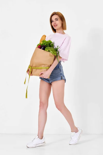 Young Sporty Woman Holding Shopping Bag Full Groceries Measuring Tape — стоковое фото