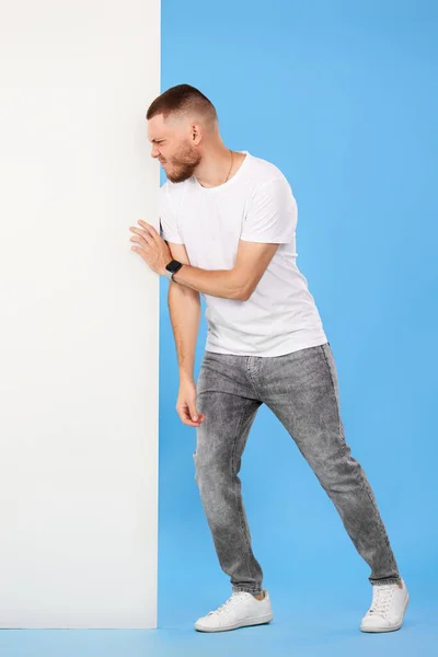 Cheerful Bearded Man Pushing Board Empty Copy Space Isolated Blue — Foto Stock