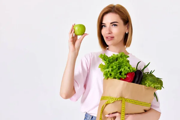 Young Caucasian Woman Pink Shirt Holds Paper Bag Vegetables Shows — Foto de Stock