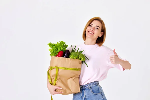 Smiling Caucasian Slim Woman Holds Paper Bag Vegetables Measuring Tape — Foto de Stock