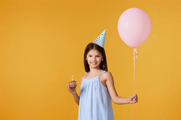 Smiling Little Child Girl Party Cone Holding Cupcake Balloon Her — стоковое фото