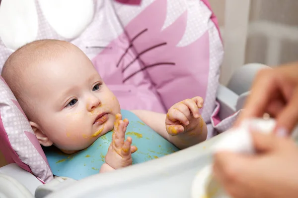 Cute Baby Girl Eating Spoon Kitchen — стоковое фото