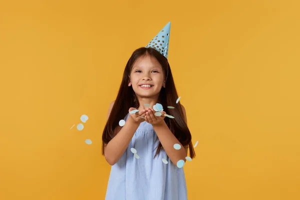 Happy Birthday Child Girl Blowing Confetti Her Hands Orange Background — Fotografia de Stock