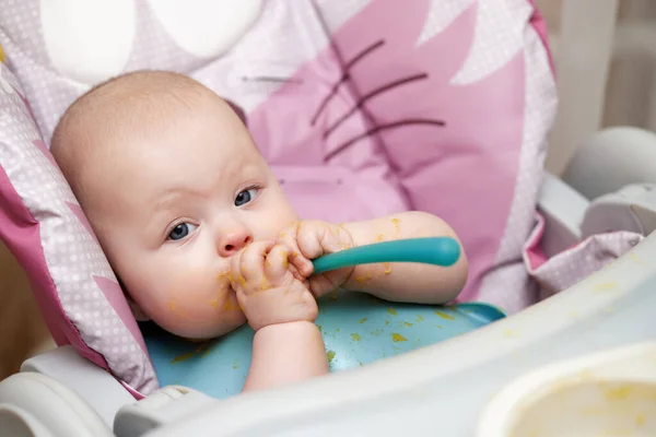 Cute Baby Girl Eating Spoon Kitchen — стоковое фото