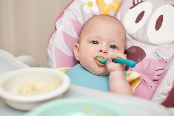 Cute Baby Girl Eating Spoon Baby Chair Kitchen — ストック写真
