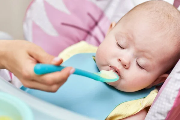 Mom Feeds Her Baby Girl Spoon Baby Chair Mother Gives — Zdjęcie stockowe