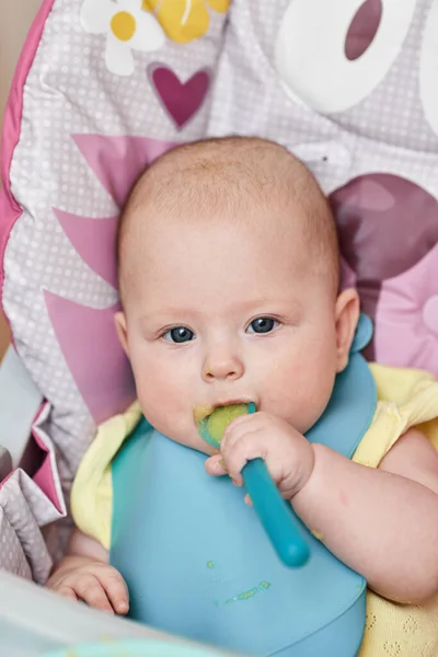 Cute Baby Girl Eating Spoon Baby Chair Kitchen — Fotografia de Stock