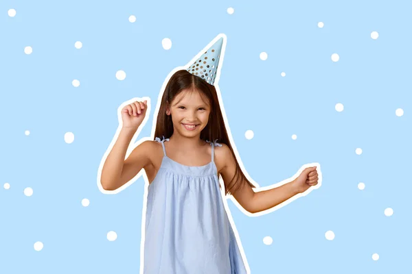 happy birthday child girl in blue dress and party hat dancing on blue background