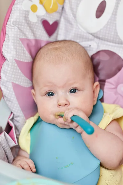 Cute Baby Girl Eating Spoon Baby Chair Kitchen — ストック写真