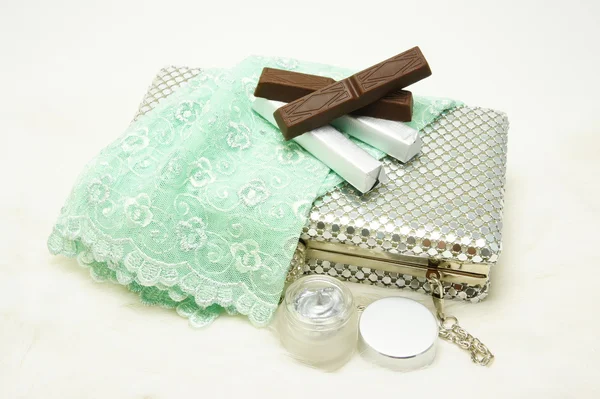 Evening bag with lace gloves, chocolate and cosmetic. — Stock Photo, Image