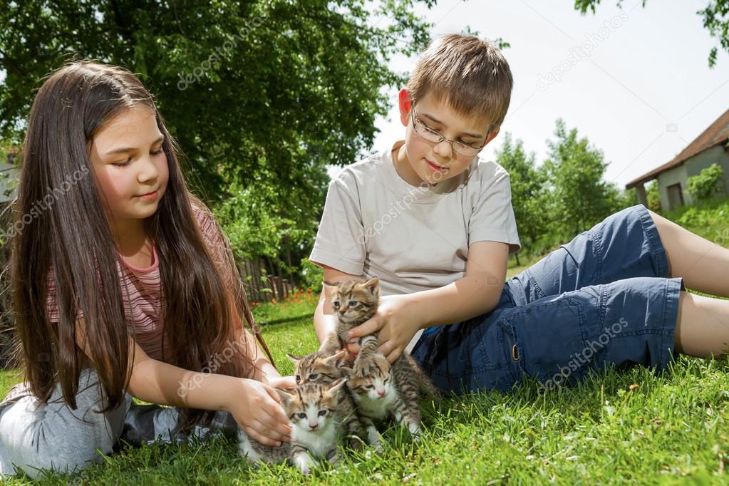 Happy children with a little cat