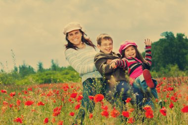 Vintage family on the poppy meadow clipart