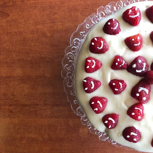 selective focus. Strawberry pie garnished with fresh strawberries. Homemade strawberries cake made from meringue cake and cream with strawberries. Decorated with icing and berries. birthday cake with smiley face.