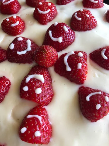 selective focus. Strawberry pie garnished with fresh strawberries. Homemade strawberries cake made from meringue cake and cream with strawberries. Decorated with icing and berries. birthday cake with smiley face.