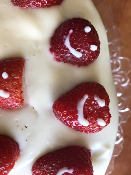 selective focus. Strawberry pie garnished with fresh strawberries. Homemade strawberries cake made from meringue cake and cream with strawberries. Decorated with icing and berries. birthday cake with smiley face.