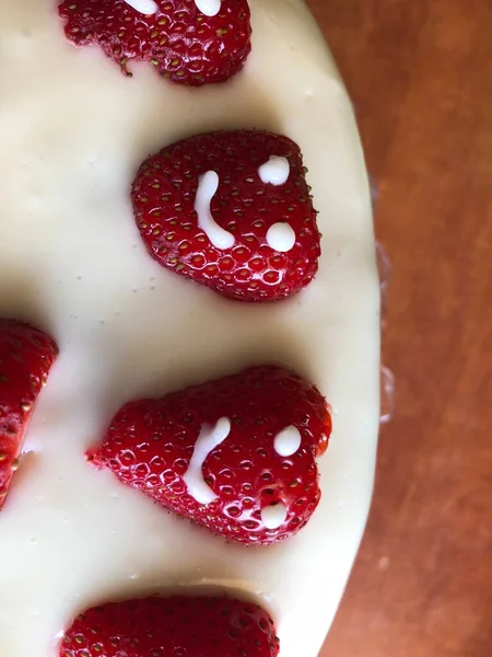 selective focus. Strawberry pie garnished with fresh strawberries. Homemade strawberries cake made from meringue cake and cream with strawberries. Decorated with icing and berries. birthday cake with smiley face.