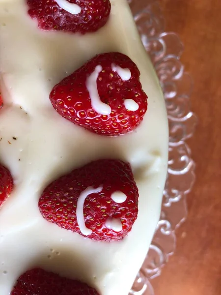 selective focus. Strawberry pie garnished with fresh strawberries. Homemade strawberries cake made from meringue cake and cream with strawberries. Decorated with icing and berries. birthday cake with smiley face.