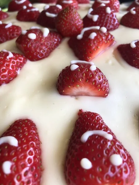 selective focus. Strawberry pie garnished with fresh strawberries. Homemade strawberries cake made from meringue cake and cream with strawberries. Decorated with icing and berries. birthday cake with smiley face.