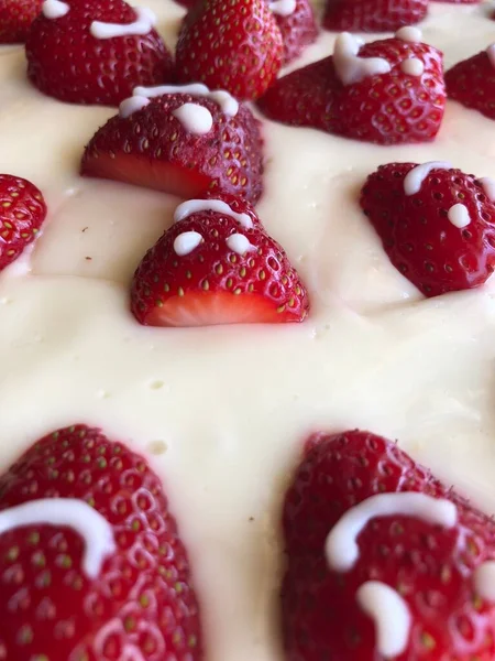 selective focus. Strawberry pie garnished with fresh strawberries. Homemade strawberries cake made from meringue cake and cream with strawberries. Decorated with icing and berries. birthday cake with smiley face.