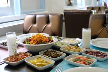Traditional Turkish meze and appetizers on dinner table. Mazzeh, Meze, Mezze, or Mazza is a selection of small dishes served as appetizers in much of West Asia and the Balkans. 