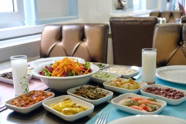 Traditional Turkish meze and appetizers on dinner table. Mazzeh, Meze, Mezze, or Mazza is a selection of small dishes served as appetizers in much of West Asia and the Balkans. 