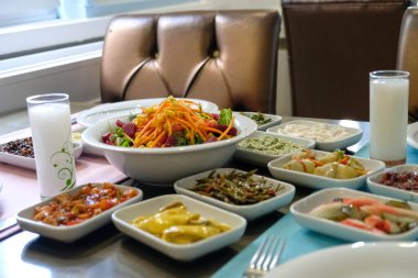 Traditional Turkish meze and appetizers on dinner table. Mazzeh, Meze, Mezze, or Mazza is a selection of small dishes served as appetizers in much of West Asia and the Balkans. 