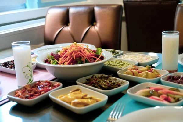 Traditional Turkish meze and appetizers on dinner table. Mazzeh, Meze, Mezze, or Mazza is a selection of small dishes served as appetizers in much of West Asia and the Balkans. 