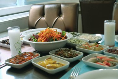 Traditional Turkish meze and appetizers on dinner table. Mazzeh, Meze, Mezze, or Mazza is a selection of small dishes served as appetizers in much of West Asia and the Balkans. 