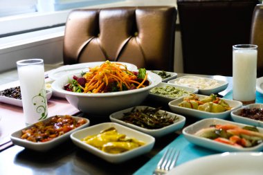 Traditional Turkish meze and appetizers on dinner table. Mazzeh, Meze, Mezze, or Mazza is a selection of small dishes served as appetizers in much of West Asia and the Balkans. 
