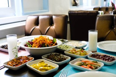 Traditional Turkish meze and appetizers on dinner table. Mazzeh, Meze, Mezze, or Mazza is a selection of small dishes served as appetizers in much of West Asia and the Balkans. 