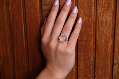 Woman Jewelery concept. Womans hands close up wearing rings and necklace modern accessories elegant life style with copy space for text and background. jewelry diamond ring.