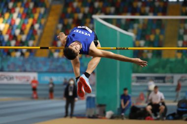 ISTANBUL, TURKEY - DECEMBER 25, 2021: Undefined athlete high jumping during Turkish Athletic Federation Indoor Athletics Record Attempt Races