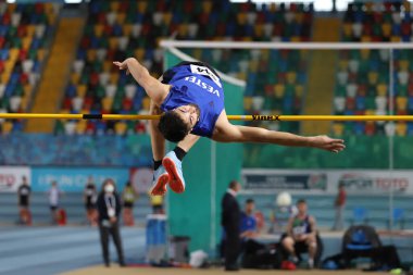 ISTANBUL, TURKEY - DECEMBER 25, 2021: Undefined athlete high jumping during Turkish Athletic Federation Indoor Athletics Record Attempt Races