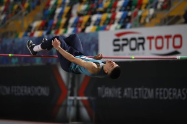 ISTANBUL, TURKEY - FEBRUARY 26, 2022: Undefined athlete high jumping during Turkish Indoor Athletics Championships in Atakoy Athletics Arena