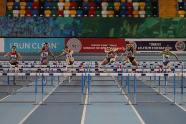 ISTANBUL, TURKEY - MARCH 05, 2022: Athletes running 60 metres hurdles during Balkan Athletics Indoor Championships in Atakoy Athletics Arena