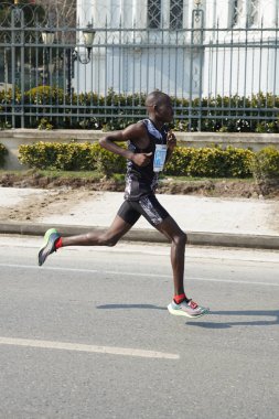 ISTANBUL, TURKEY - NOVEMBER 07, 2021: Athlete running Istanbul half marathon in historic street of Fener district